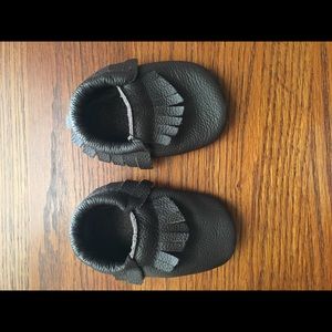 Brown leather moccasins and knee pads